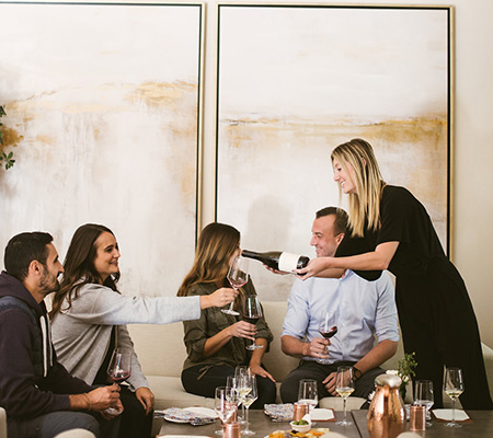 guest enjoying Adelaida signature room. Pictured with wine and cheese pairing. 